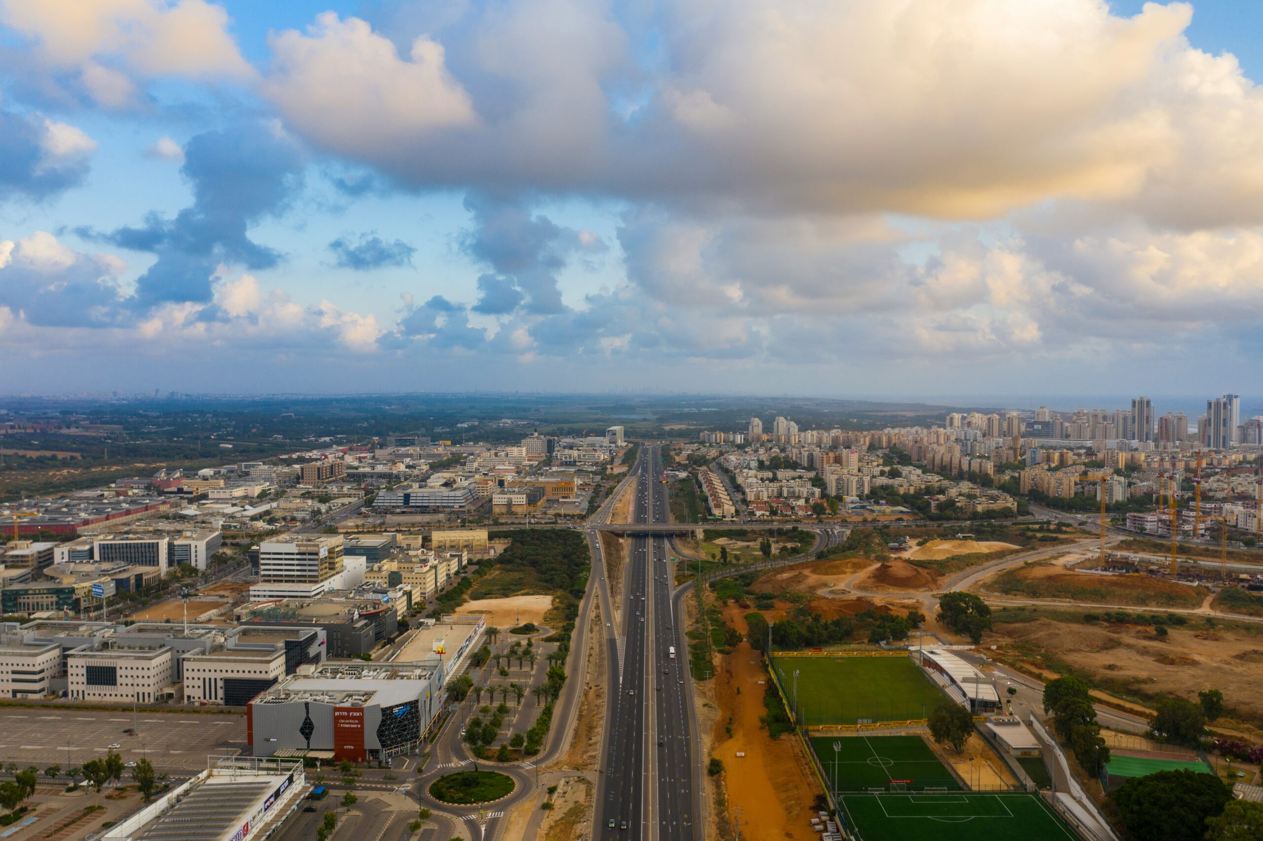 Aerial photo of a highway in Israel. Fields in the background.